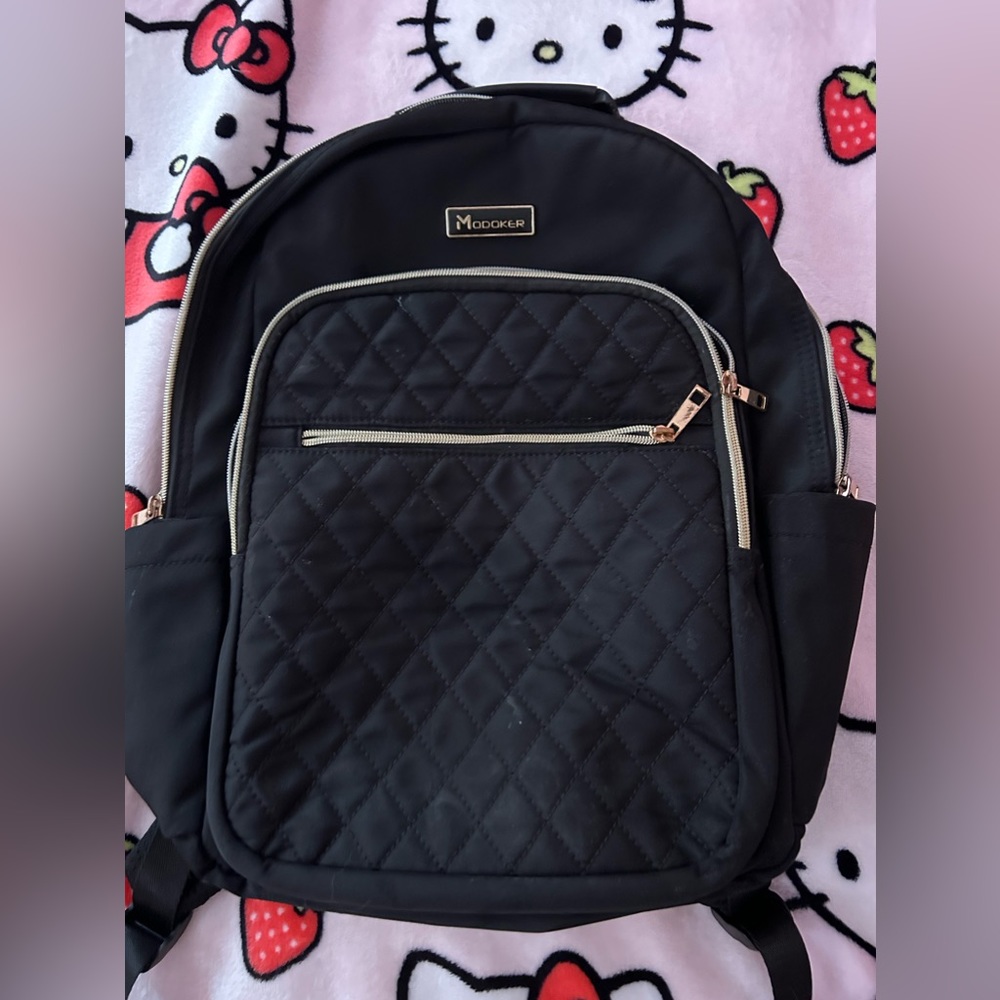 modoker backpack! Very spacious and has a charger input!! Fits laptops and etc
